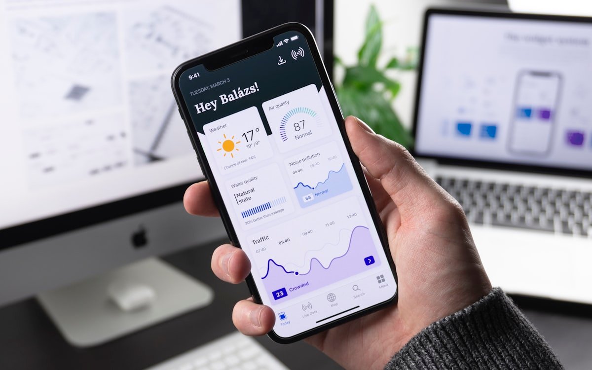 Mobile app dashboard held in a hand